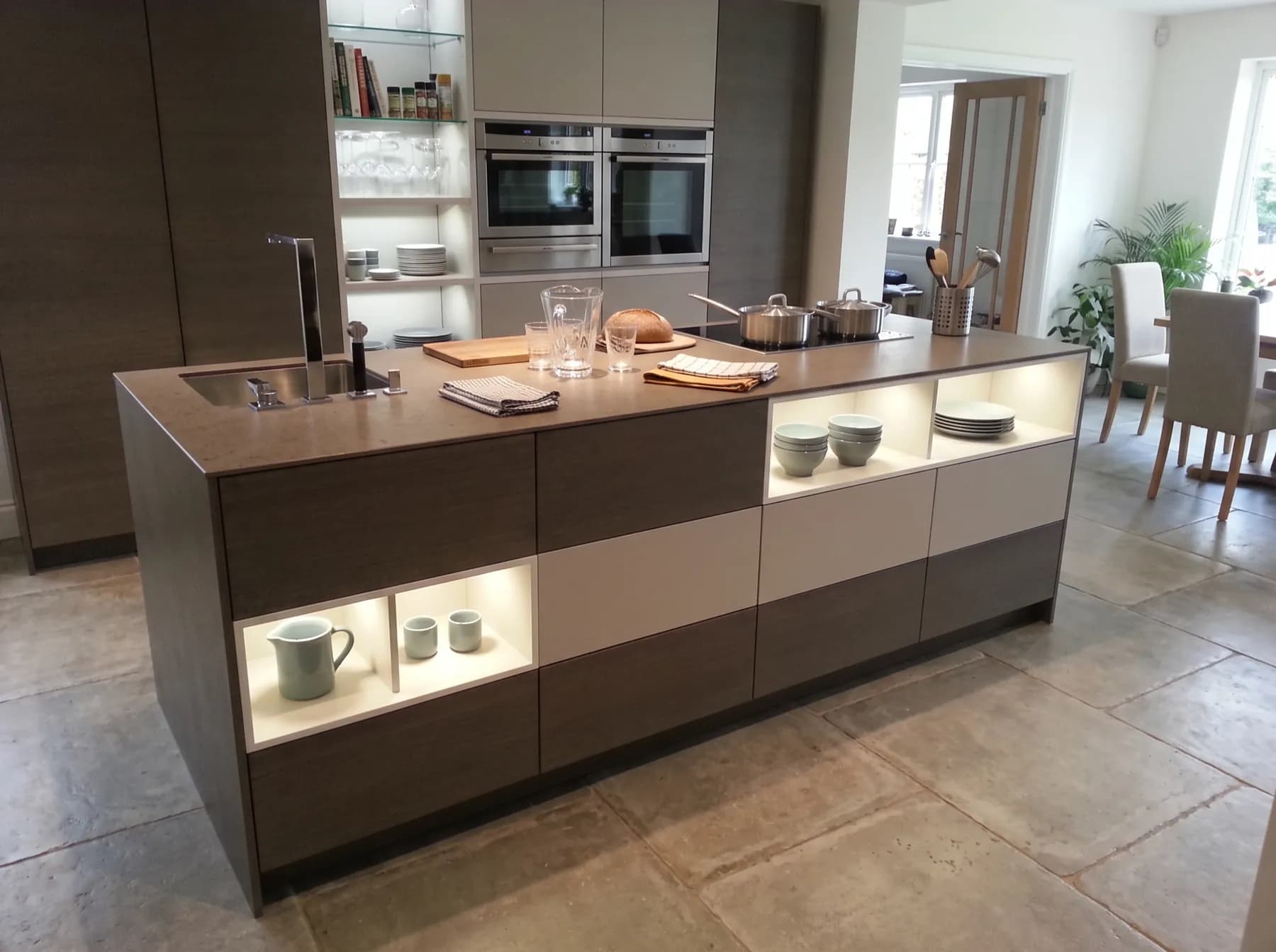 Walnut kitchen island with LED-lit niches